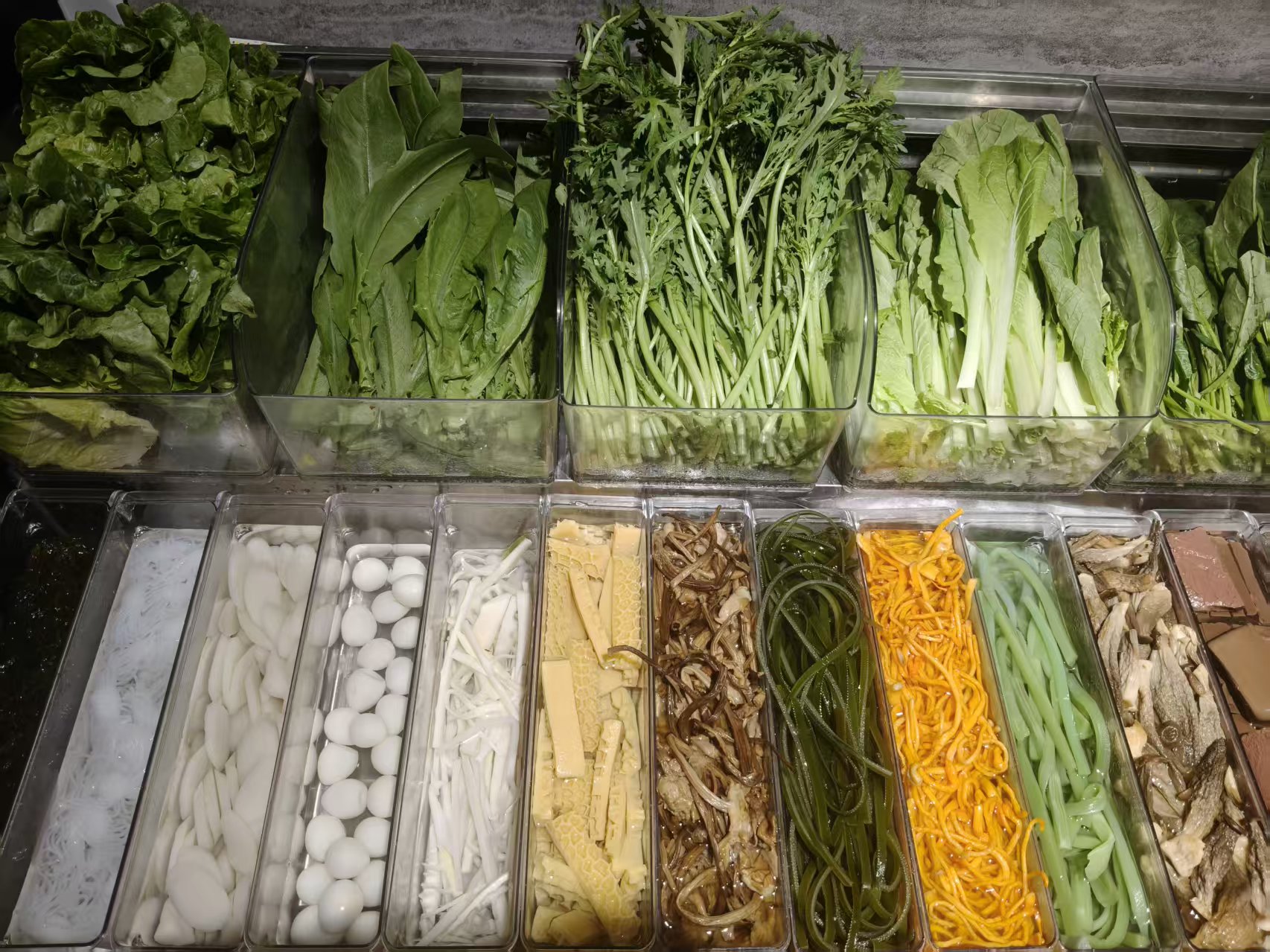 Fresh vegetables and toppings in the ingredient bar