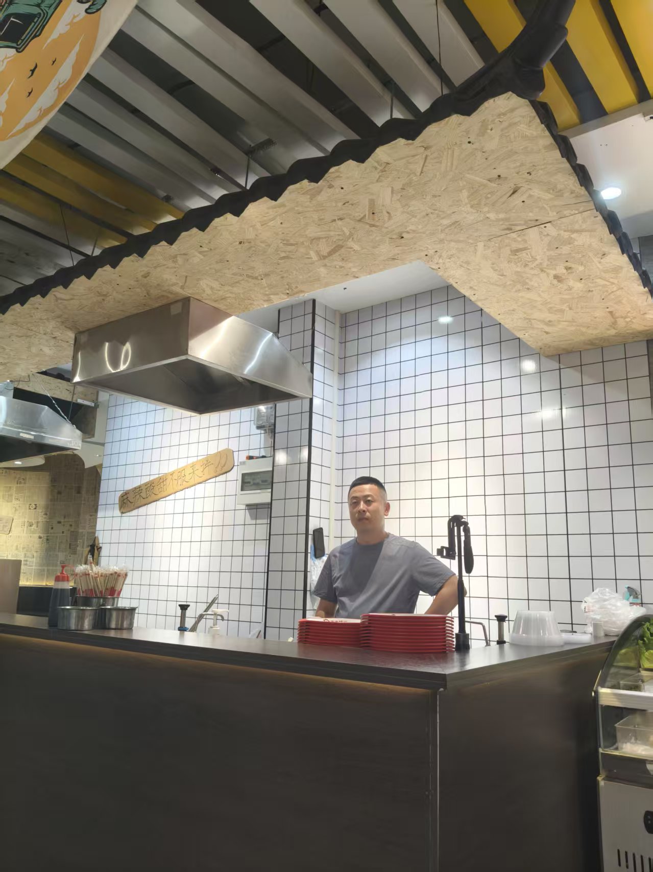 Owner standing behind the counter